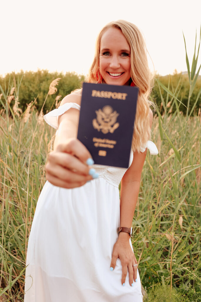 Megan Lanford of Points Too Paradise holding a passport. She shares how to hack luxury travel with credit card points.